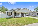 Inviting single-story home with a covered carport, dark shutters, and a well-manicured front yard at 1623 Cumbie Ave, Orlando, FL 32804