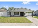 Charming single-story home featuring a cozy porch swing and carport at 1623 Cumbie Ave, Orlando, FL 32804