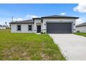 Single Gathering house features a two-car garage and modern architectural details with a blue sky background at 17139 Sw 44Th Cir, Ocala, FL 34473