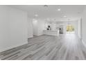 Bright open-concept living area with gray wood-look flooring and recessed lighting at 17434 Sw 36Th Avenue Rd, Ocala, FL 34473