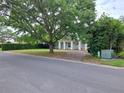 Attractive home with mature shade tree, manicured hedges, and brick driveway creating a welcoming curb appeal at 1773 Walnut Ave, Winter Park, FL 32789
