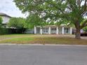 Single-story home with dual entrances, brick driveway, and mature trees, blending comfort and curb appeal at 1773 Walnut Ave, Winter Park, FL 32789