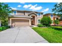 Charming two-story home with a well-manicured lawn and inviting curb appeal on a beautiful day at 2209 Crofton Ave, Davenport, FL 33837