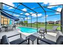 Relaxing screened-in pool area with ample seating, lounge chairs and outdoor dining space at 2209 Crofton Ave, Davenport, FL 33837