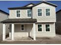 Charming two-story home with a covered front porch and neutral-colored siding at 2371 Zuni Road, St Cloud, FL 34771