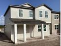 Inviting two-story home featuring a covered porch and light-colored exterior at 2371 Zuni Road, St Cloud, FL 34771