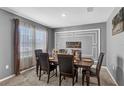 Formal dining area featuring a sophisticated dark wood table, six chairs, and elegant wall decor at 269 Ludisia Loop, Davenport, FL 33837