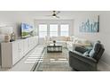 Bright and airy living room features lots of natural light, a comfortable sofa, and stylish decor at 4063 Roaming Brook Dr, Apopka, FL 32712