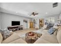 Open-concept living room with modern furnishings, wood floors, ceiling fan, and great views of the kitchen at 4306 Lake Underhill Rd # C, Orlando, FL 32803