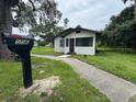 Exterior view of home featuring a black mailbox and walkway leading to a screened-in porch at 506 South St, Daytona Beach, FL 32114