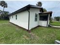 Exterior side view of newly renovated home with updated features and new landscaping at 506 South St, Daytona Beach, FL 32114