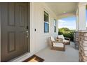 Inviting front porch featuring chairs with stone pillars, perfect for relaxing at 5700 Iron Brand Rd, St Cloud, FL 34771
