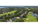 Aerial view showcases the property's location on a golf course, surrounded by lush landscaping at 5950 Blakeford Dr, Windermere, FL 34786