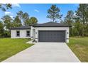 Charming single-story home with a well-maintained lawn and a two-car garage at 6062 Sw 154Th Pl, Ocala, FL 34473