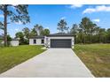 Charming single-story home with a well-maintained lawn and a two-car garage at 6062 Sw 154Th Pl, Ocala, FL 34473