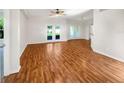 Spacious living area with gleaming hardwood floors and natural light, ideal for relaxing and entertaining guests at 704 Pickfair Ter, Lake Mary, FL 32746