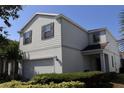 Two-story home boasts a two-car garage, well-maintained landscaping, and traditional architectural details at 8926 Zurich Ln, Kissimmee, FL 34747