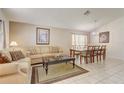Comfortable living room with tile floors, neutral paint, and ample space for entertaining at 927 Orange Cosmos Blvd, Davenport, FL 33837