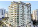 Beautiful view of a high-rise condo building with balconies and a serene pool area with palm trees at 100 S Eola Dr # 611, Orlando, FL 32801