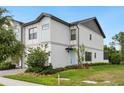Contemporary two-story home with clean lines, manicured lawn, and a charming light blue front door at 10251 Ebb Tide Ln, Orlando, FL 32821