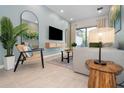 Cozy living room featuring neutral tones, a large TV, modern décor, and access to the outdoors at 10251 Ebb Tide Ln, Orlando, FL 32821