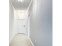 Bright hallway with tile flooring, crown molding, and elegant lighting fixtures leading to front door at 1120 Saguaro St, Haines City, FL 33844