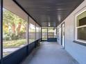 Screened in porch featuring an outdoor ceiling light and a view of the front yard at 1229 Deneece Ter, Daytona Beach, FL 32117