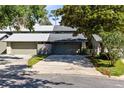 Home featuring multiple garages with stone detailing and an American flag at 140 Deer Lake Cir, Ormond Beach, FL 32174