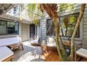 Cozy outdoor patio with stone flooring, seating, and tropical landscaping at 140 Deer Lake Cir, Ormond Beach, FL 32174