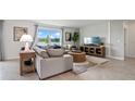 Comfortable living room featuring stylish decor, a large window with scenic views, and an inviting sofa at 1495 Fountain View St, Ormond Beach, FL 32174