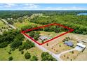 Aerial view of the property showcasing the houses, pool, barn, road and property lines at 1508 Lake Mills Rd, Chuluota, FL 32766