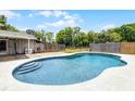 Inviting kidney-shaped pool with sun deck and fenced in yard for your enjoyment at 1508 Lake Mills Rd, Chuluota, FL 32766