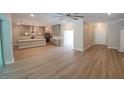 An open floorplan shows living room, kitchen with stainless appliances, and hardwood floors at 160 Steeplechase Cir, Sanford, FL 32771