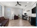 A well-lit office with a sofa, desk, and plenty of natural light at 1716 Wild Indigo Ter, Oviedo, FL 32766
