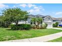 Attractive single-Gathering home with lush landscaping, and a well-maintained lawn at 17200 Gathering Place Cir, Clermont, FL 34711