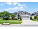 Beautiful one-story home with a lush front lawn and a charming facade at 17200 Gathering Place Cir, Clermont, FL 34711