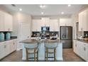 Modern kitchen with stainless steel appliances, a center island with seating, and stylish backsplash at 1869 Clear Sky Dr, Kissimmee, FL 34744