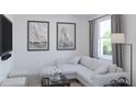Bright living room with white sofa, contemporary decor, and large window overlooking the yard at 1901 Fulfillment Dr, Kissimmee, FL 34744
