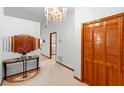 Foyer with tile floors, chandelier and wooden closet doors provides an elegant entryway at 2018 N Normandy Blvd, Deltona, FL 32725