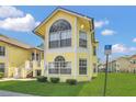 Inviting yellow condo with ample windows and accessible parking at 2040 Royal Bay Blvd # 31, Kissimmee, FL 34746