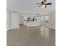 Open-concept living area with modern lighting and seamless access to the kitchen at 2040 Royal Bay Blvd # 31, Kissimmee, FL 34746