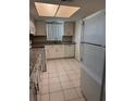 Bright kitchen featuring white cabinets, granite countertops, and white appliances at 2408 Swailes Dr # 6, Orlando, FL 32837