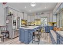 Stylish kitchen featuring a large island, stainless steel appliances, and two-tone cabinetry at 2418 W 1St St, Sanford, FL 32771