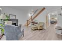 Comfortable living room with hardwood floors, fireplace, and staircase at 2418 W 1St St, Sanford, FL 32771