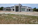 Modern home under construction, displaying its concrete framework, window placement, and architectural design at 26019 Estates Ridge Dr, Sorrento, FL 32776