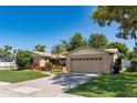 Beautiful home with a well-maintained lawn, mature trees, and a two-car garage at 3121 Thistlehill Drive, Winter Park, FL 32792
