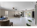 Spacious living room showcases the kitchen, modern floors, and bright light from the glass paneled doors at 410 W Seminole Ave, Eustis, FL 32726