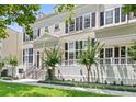 Charming two-story townhouse featuring black shutters, a well-manicured lawn, and attractive landscaping at 476 Water St, Celebration, FL 34747