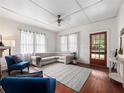 Bright living room featuring hardwood floors, a comfortable sectional sofa, and natural light from large windows at 485 Palm St, Winter Garden, FL 34787