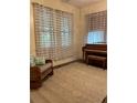 Bright room with piano, rocking chair, and large patterned area rug at 485 Palm St, Winter Garden, FL 34787